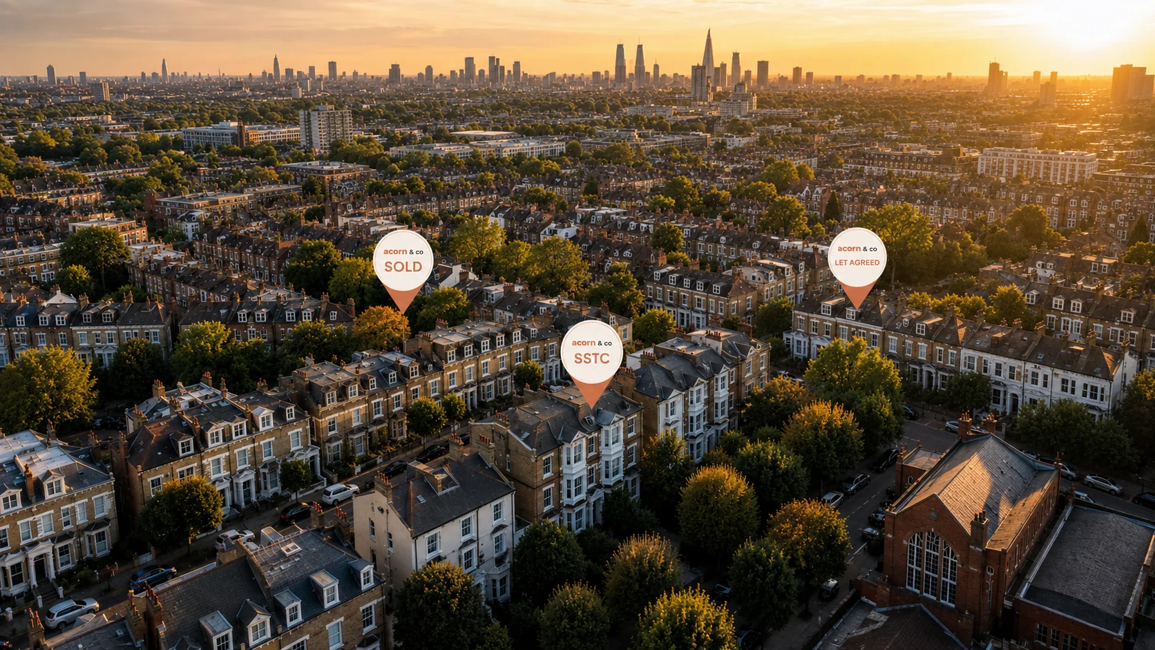 An aerial sunset shot of London suburbs with acorn sold and SSTC pins